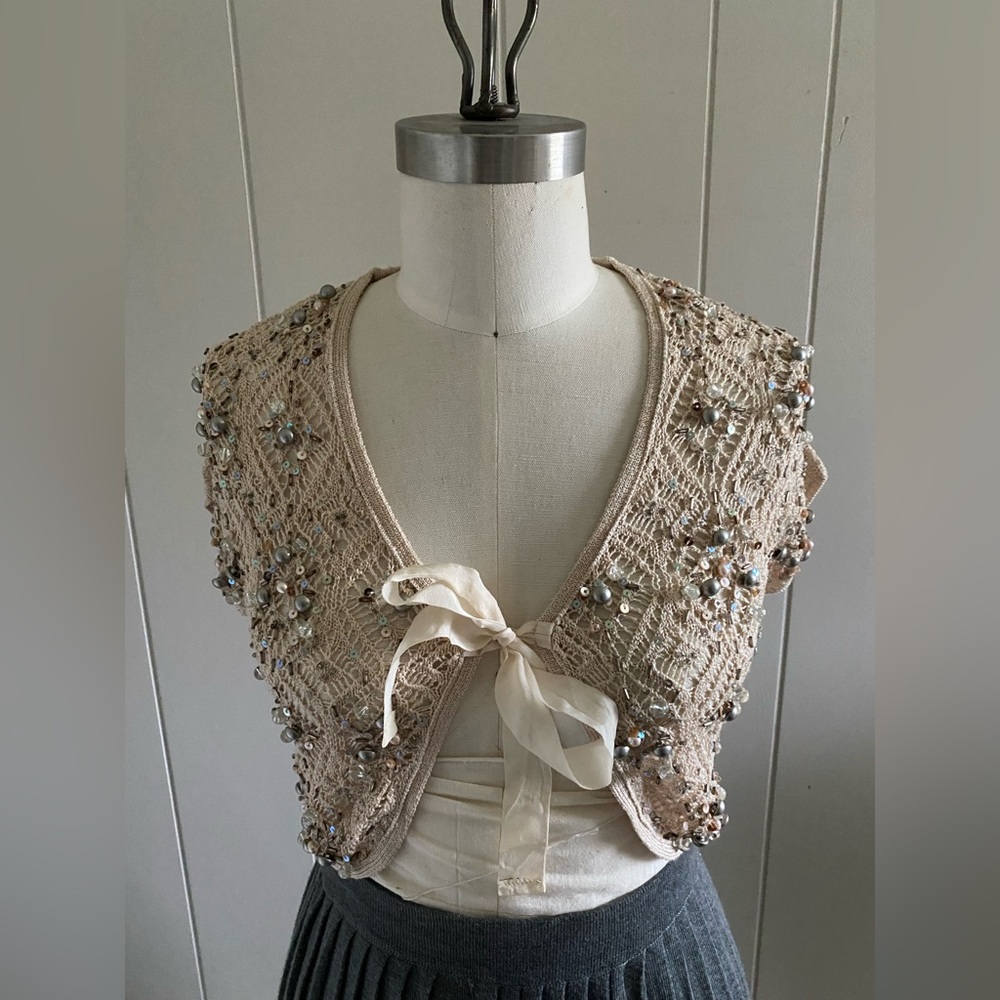 Cropped, cap sleeve, bolero cardigan with intricate pointelle stitch & beading.
